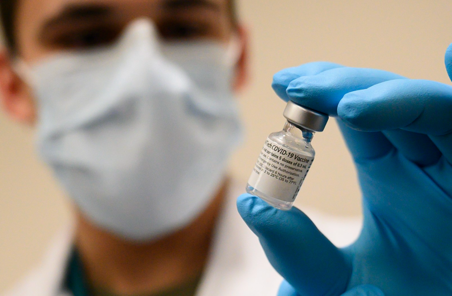 Army Spc. Angel Laureano holds a vial of the COVID-19 vaccine, Walter Reed National Military Medical Center, Bethesda, Md., Dec. 14, 2020. 