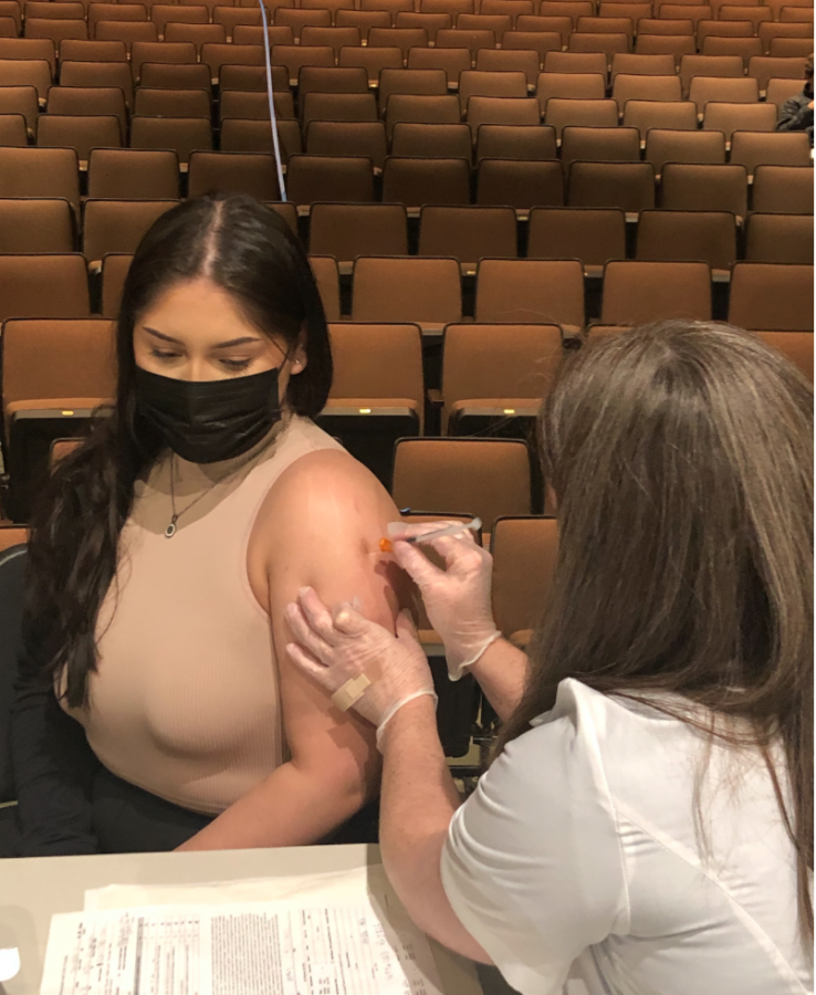 Senior Melisa Rodriguez receives her first dose of the Pfizer vaccine in the Romano Family Theatre on Friday, April 23.