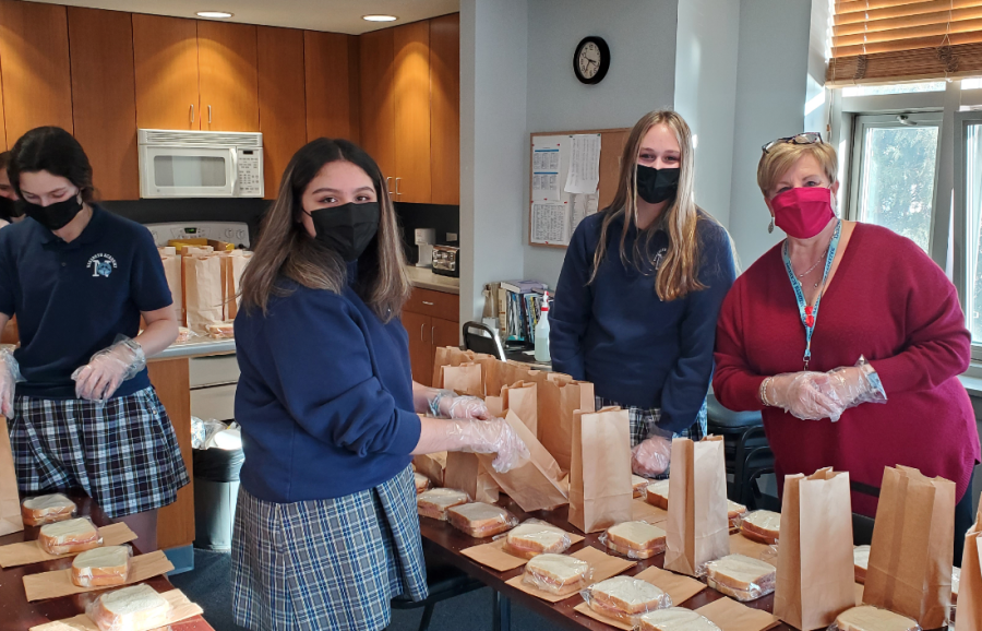 Sophomore+Kacey+Hughes%2C+Freshman+Carolina+Gonzalez%2C+Sophomore+%0AHannah+Hesser+and+Principal+Therese+Hawkins+packing+sandwiches+for+sandwich+ministry.+
