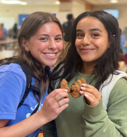 Seniors Natalie Ereio and Ashlynn Rodriguez share a Quest chocolate chip cookie at lunch.