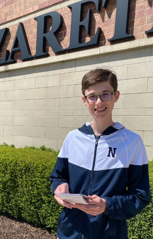 Miles Hayford with his reporter’s notebook from freshman year. 
