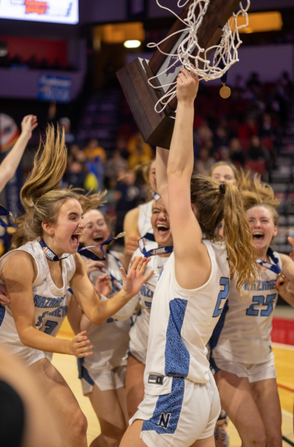 The girls basketball team celebrates after winning the State Championship. 
