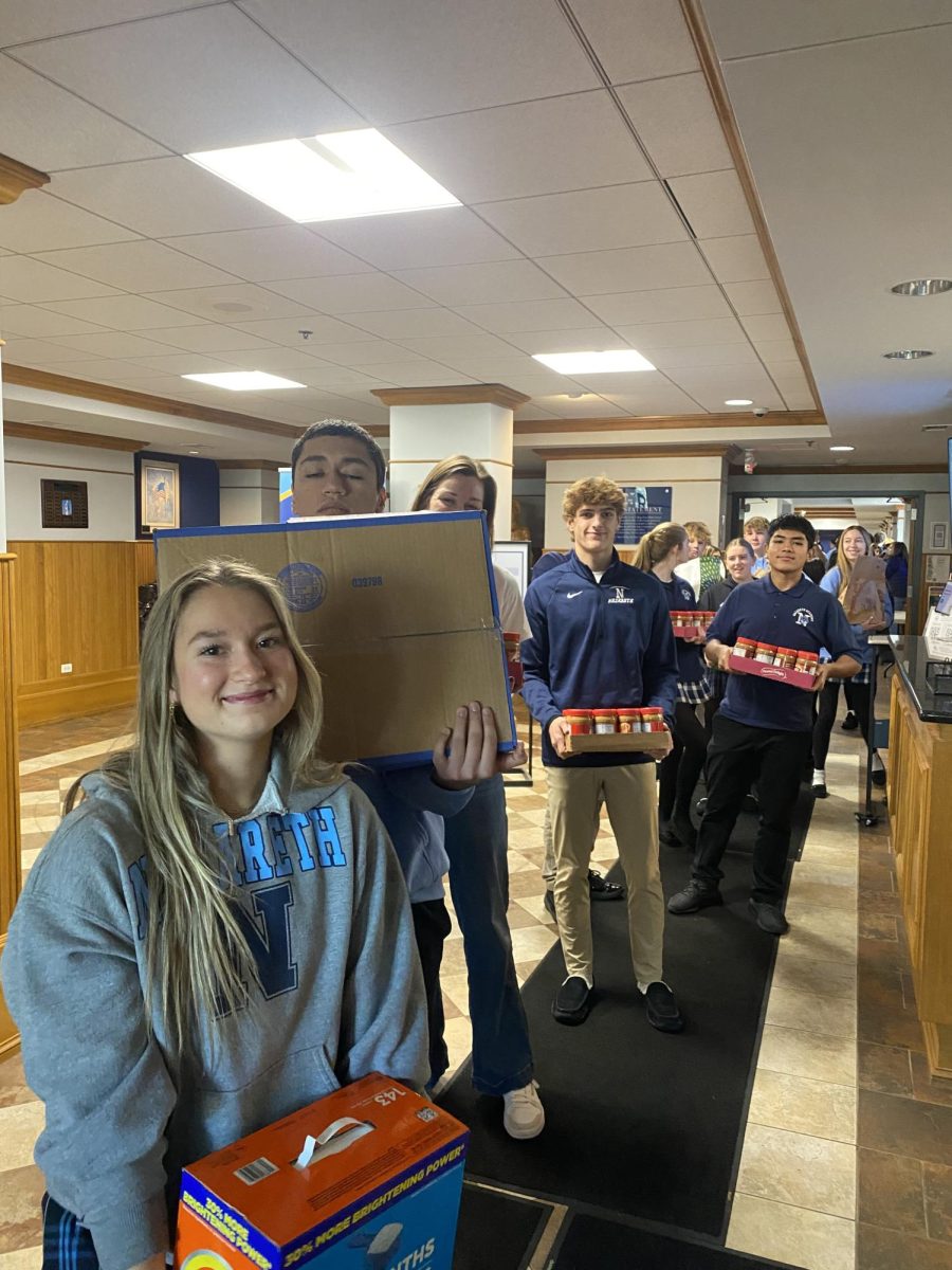 On Friday morning, November 14th, student volunteers line up with food donations to pack the van headed to St. Francis Xavier. 